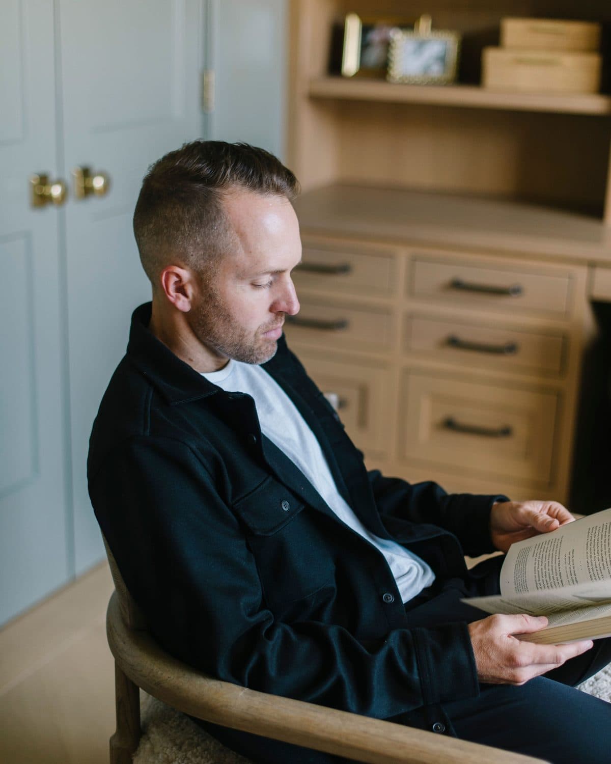Kevin reading in a chair